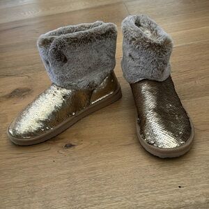 Ugg like boots. Never worn. Furry but with gold sparkles. New!